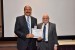 Dr. Nagib Callaos, General Chair, giving Prof. Sherif Hashem the best paper award certificate of the session "Computer Science and Cyber-Security." The title of the awarded paper is "Towards a National Cybersecurity Strategy: The Egyptian Case ."